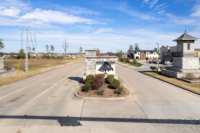 view of street featuring a residential view and curbs