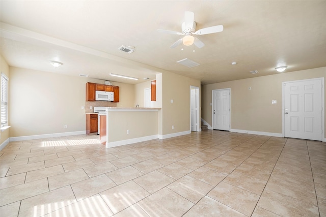 unfurnished living room with light tile patterned floors, ceiling fan, visible vents, and baseboards