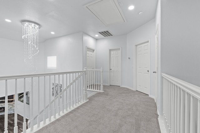 hall with recessed lighting, carpet floors, visible vents, an upstairs landing, and attic access