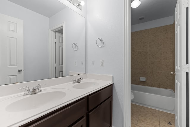 bathroom with tile patterned flooring, a sink, toilet, and double vanity