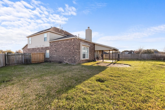 rear view of property featuring a patio, a fenced backyard, brick siding, a lawn, and a chimney