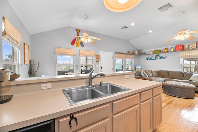 kitchen featuring open floor plan, light countertops, a sink, and visible vents