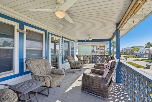 deck with a porch and ceiling fan