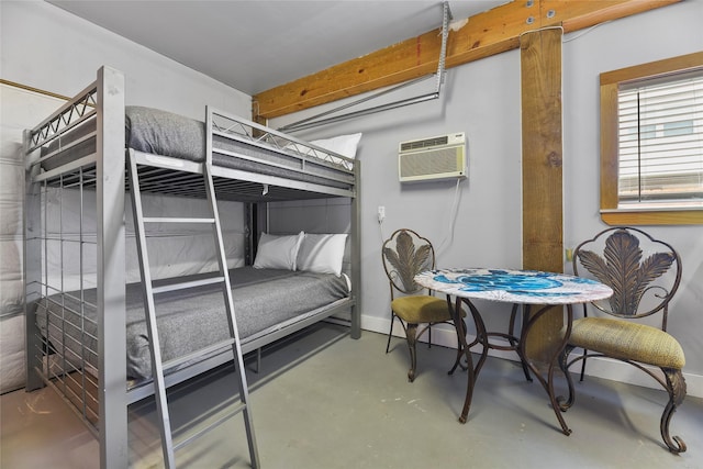 bedroom with concrete flooring, baseboards, and a wall mounted AC