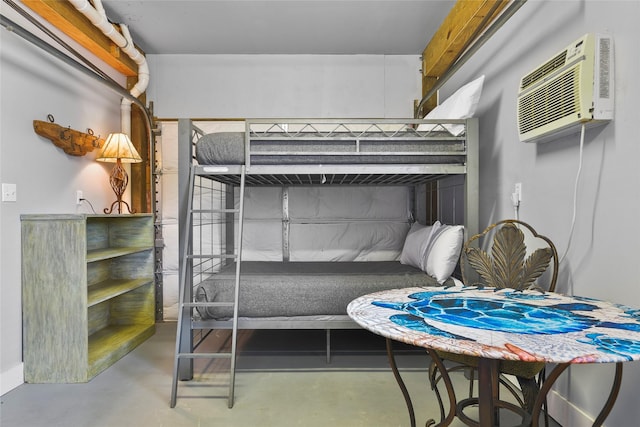 bedroom with a wall unit AC and concrete flooring