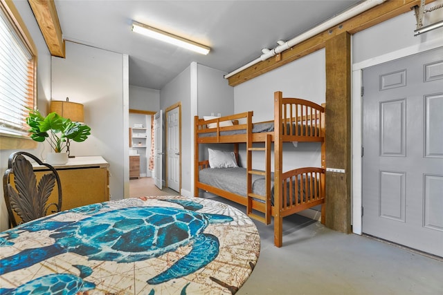 bedroom featuring concrete flooring