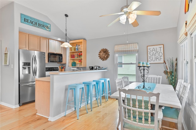 kitchen featuring stainless steel refrigerator with ice dispenser, open shelves, lofted ceiling, light countertops, and black microwave