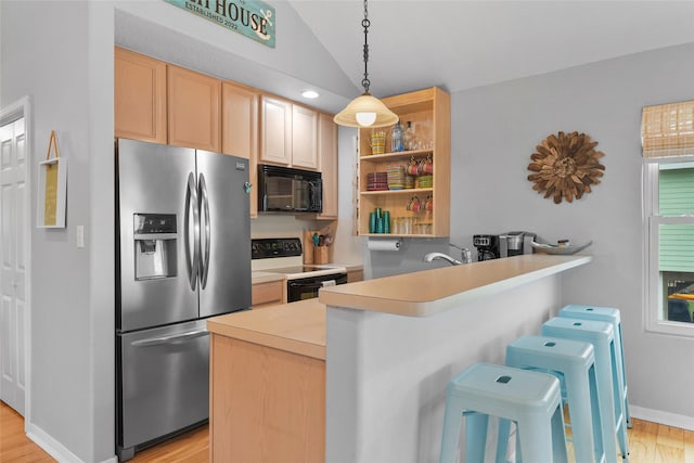 kitchen featuring black microwave, a peninsula, range with electric stovetop, light countertops, and stainless steel fridge with ice dispenser