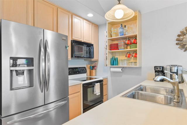 kitchen featuring light countertops, black microwave, stainless steel refrigerator with ice dispenser, a sink, and range with electric stovetop