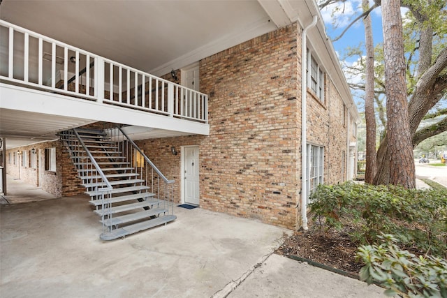 exterior space with a patio area and brick siding