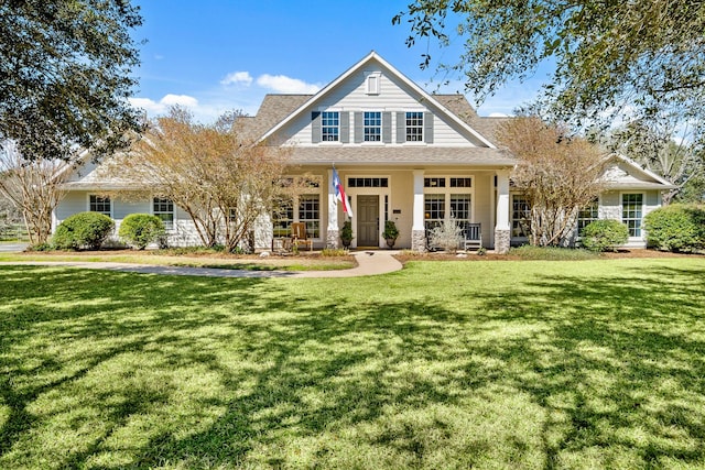 view of front of house with a porch and a front yard