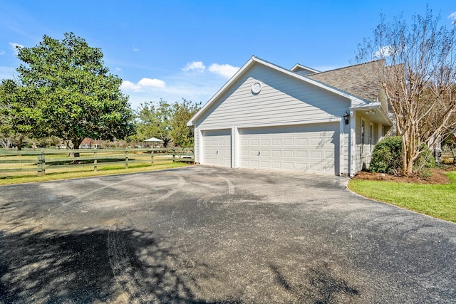 view of property exterior featuring a shingled roof