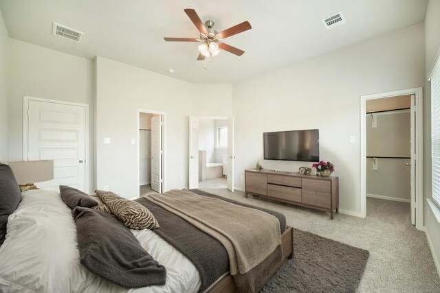 bedroom featuring light carpet, a spacious closet, a closet, and visible vents
