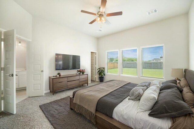 bedroom featuring a ceiling fan, light colored carpet, and visible vents