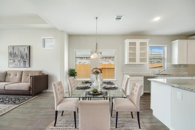 dining space with recessed lighting, visible vents, and dark wood finished floors