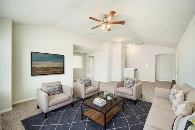 living area featuring arched walkways, lofted ceiling, visible vents, baseboards, and dark carpet
