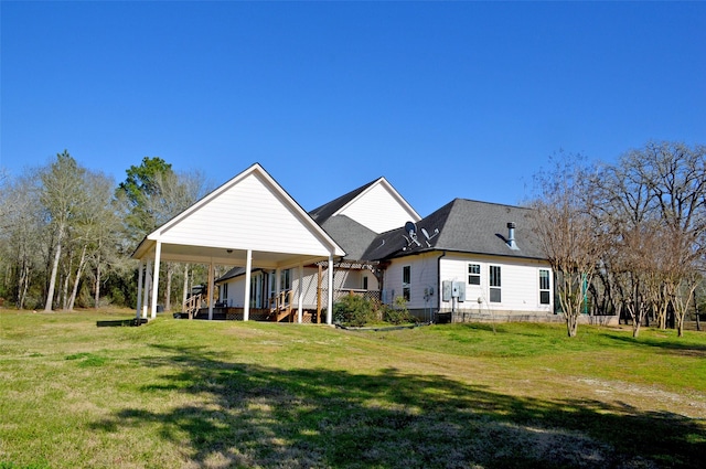 rear view of property with a porch, a yard, and a shingled roof