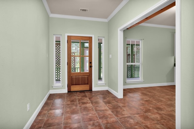 foyer featuring ornamental molding, dark tile patterned flooring, visible vents, and baseboards