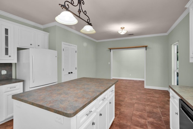 kitchen with a center island, dark countertops, glass insert cabinets, freestanding refrigerator, and white cabinetry