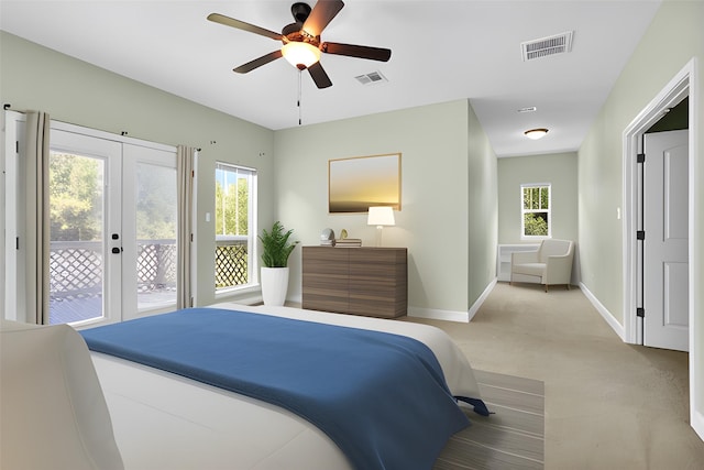 bedroom with access to outside, visible vents, baseboards, and multiple windows