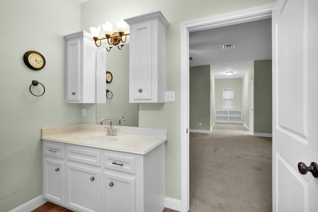 bathroom featuring visible vents, vanity, and baseboards