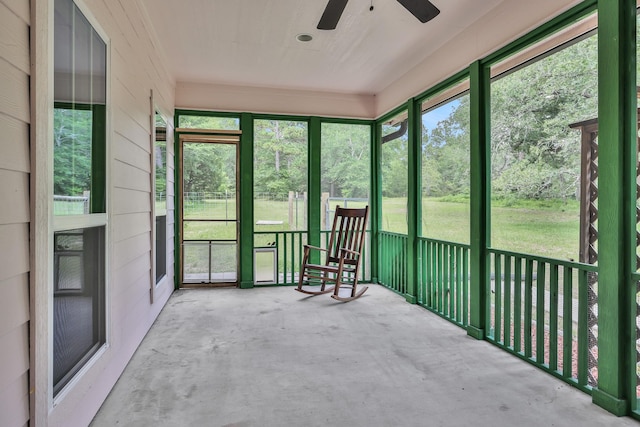 unfurnished sunroom featuring plenty of natural light and a ceiling fan