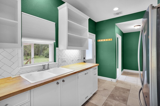 kitchen featuring white cabinetry, open shelves, a sink, and freestanding refrigerator