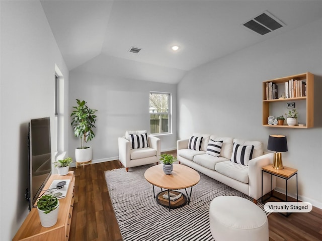 living area with baseboards, visible vents, vaulted ceiling, and dark wood-style flooring