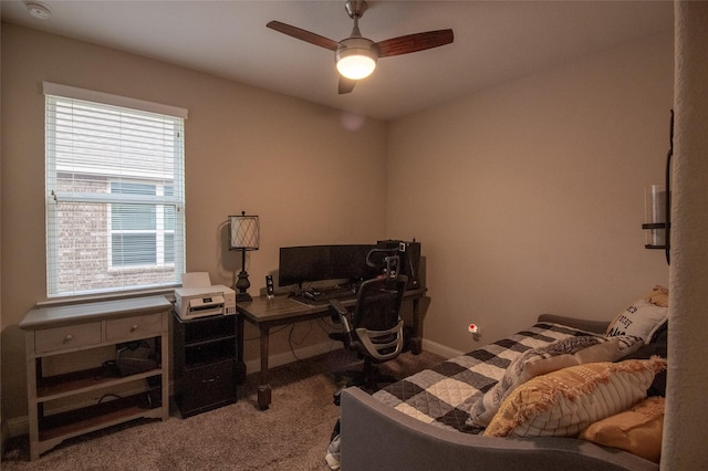 carpeted bedroom with a ceiling fan and baseboards