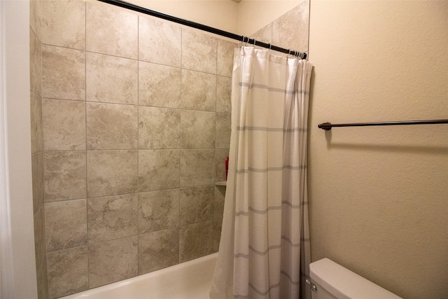 bathroom featuring shower / tub combo with curtain and toilet