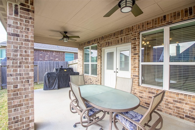 view of patio / terrace with outdoor dining area, area for grilling, fence, and a ceiling fan