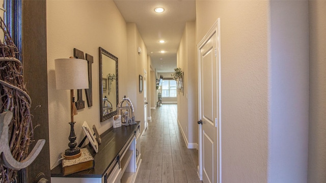 hallway with baseboards, dark wood-style flooring, and recessed lighting