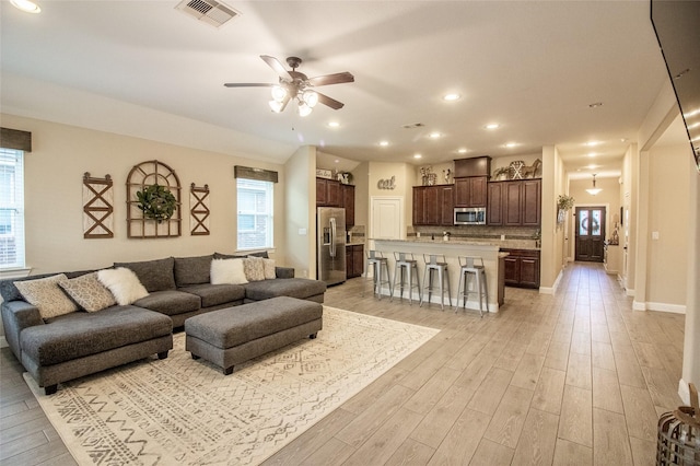 living room with light wood finished floors, recessed lighting, visible vents, a ceiling fan, and baseboards