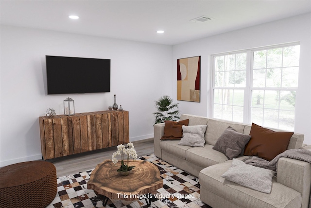 living area with light wood-type flooring, visible vents, and recessed lighting