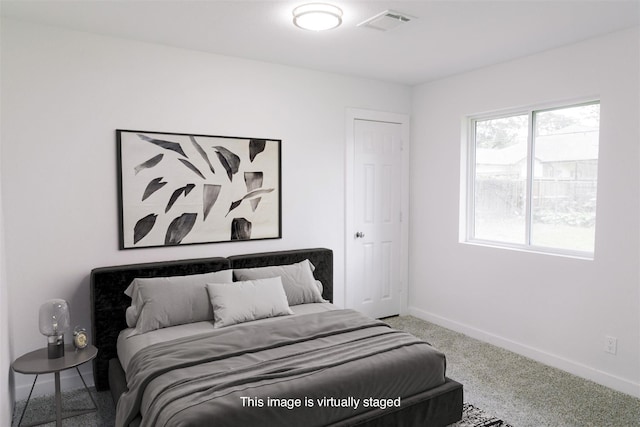 bedroom with carpet floors, visible vents, and baseboards