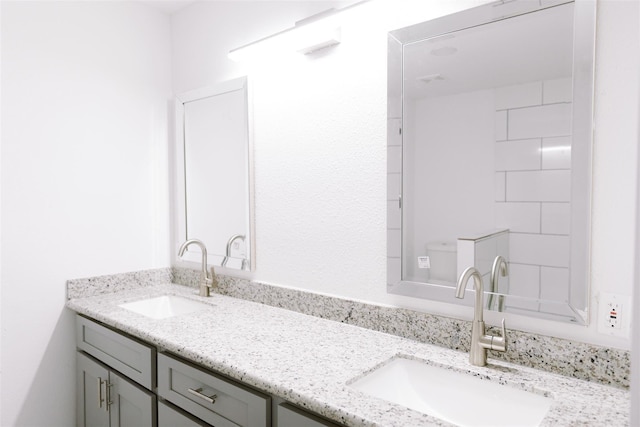 bathroom featuring a sink and double vanity