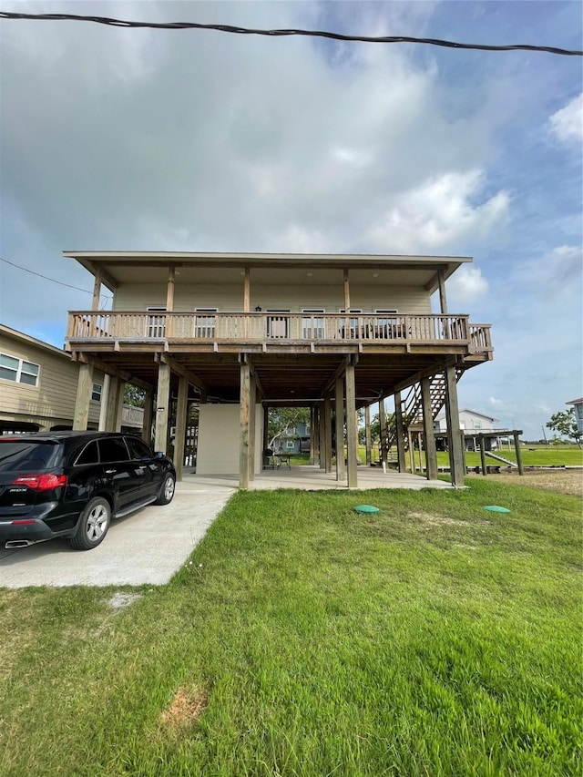 view of front of home with a carport, a wooden deck, a front lawn, and stairs