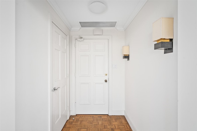 doorway to outside featuring ornamental molding, visible vents, and baseboards