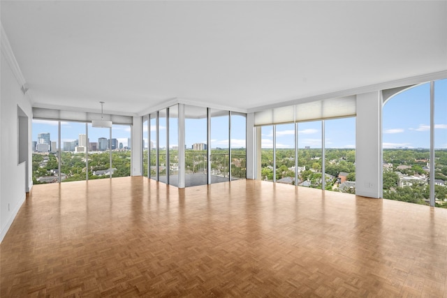 interior space with expansive windows, a view of city, and crown molding