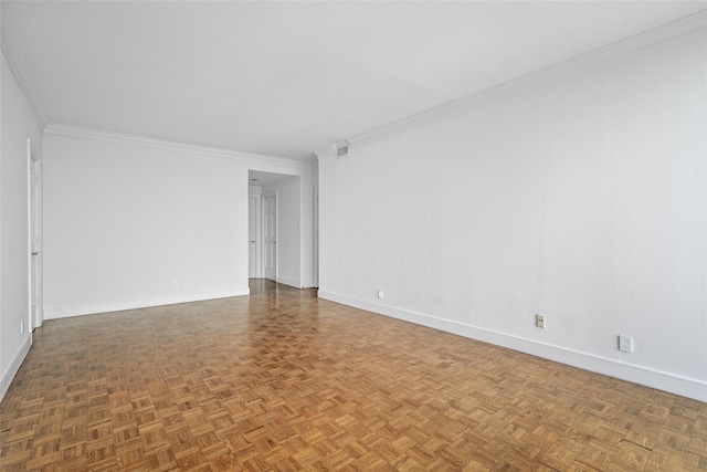 spare room with crown molding and baseboards