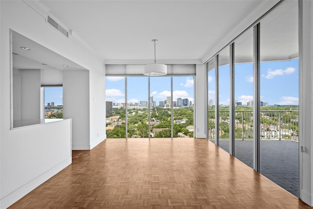 unfurnished sunroom with plenty of natural light, a view of city, and visible vents