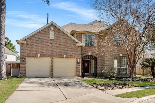 traditional-style house with an attached garage, driveway, fence, and brick siding