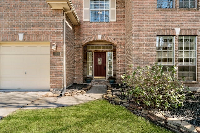 doorway to property with brick siding and an attached garage