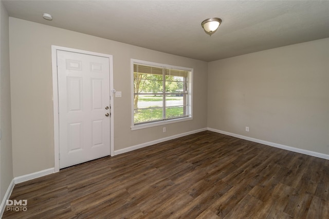 foyer entrance featuring dark wood-style floors and baseboards