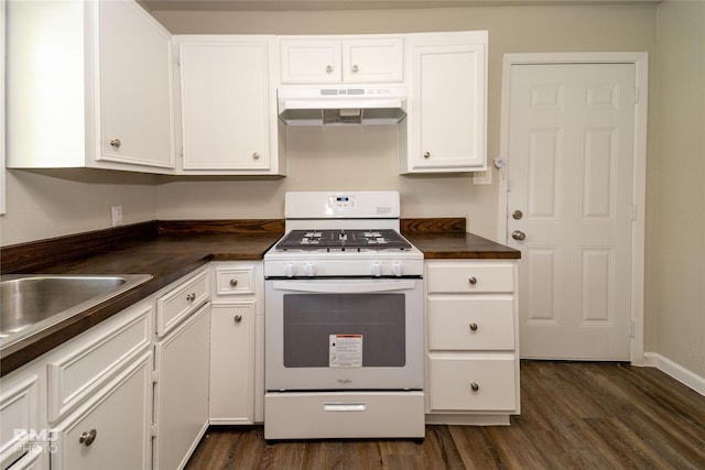 kitchen featuring dark countertops, under cabinet range hood, white cabinetry, and gas range gas stove