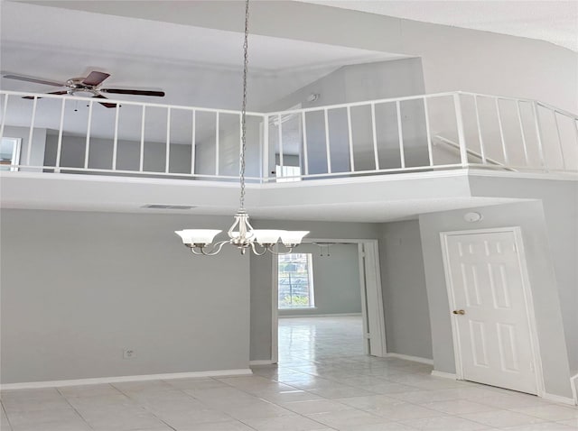 spare room with visible vents, high vaulted ceiling, baseboards, and ceiling fan with notable chandelier