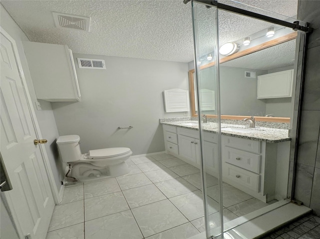 bathroom featuring visible vents, a sink, a textured ceiling, and double vanity