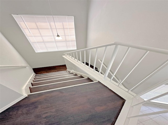 stairs featuring baseboards and wood finished floors