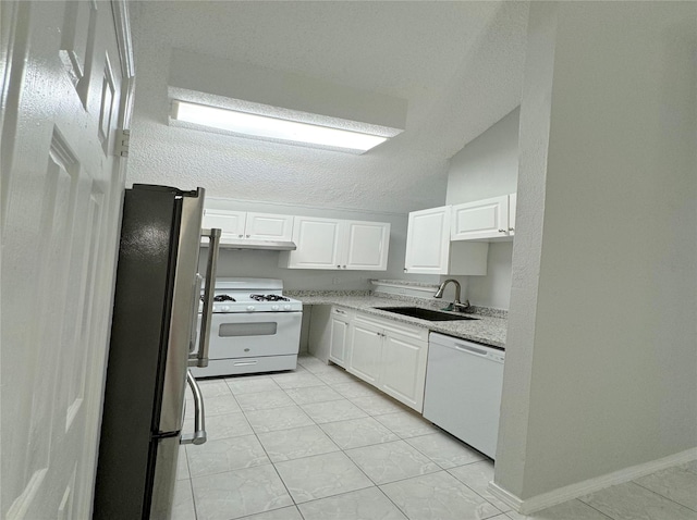 kitchen featuring under cabinet range hood, white appliances, a sink, white cabinetry, and light countertops