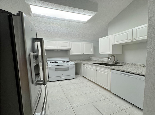 kitchen featuring white cabinetry, a sink, a textured ceiling, white appliances, and under cabinet range hood